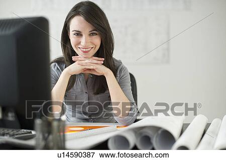 Stock Photo - Business woman with blueprints. Fotosearch