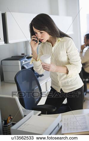 Stock Image - Business woman working in office. Fotosearch