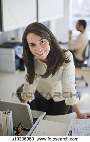 Stock Image - Business woman working in office. Fotosearch