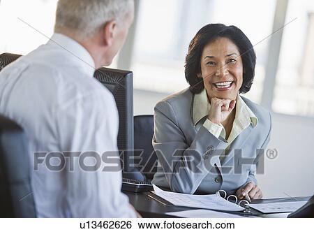 Businessman and businesswoman at meeting View Large Photo Image Stock Photograph - Businessman and businesswoman at meeting. Fotosearch