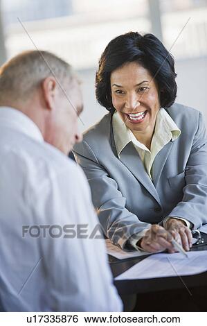 Businessman and businesswoman at meeting View Large Photo Image Stock Photograph - Businessman and businesswoman at meeting. Fotosearch