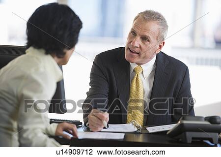 Businesswoman and businessman at meeting View Large Photo Image Stock Image - Businesswoman and businessman at meeting. Fotosearch