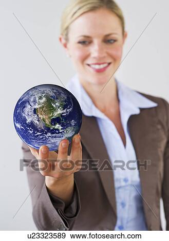 Stock Photo - Businesswoman holding globe. Fotosearch