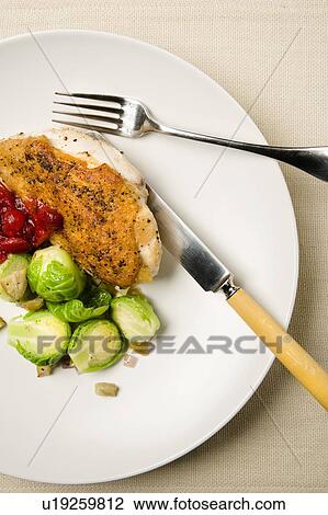 Stock Image - Chicken meal with brussels sprouts. Fotosearch