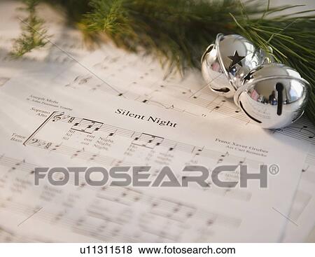 Stock Photo - Christmas baubles on carol music sheet . Fotosearch