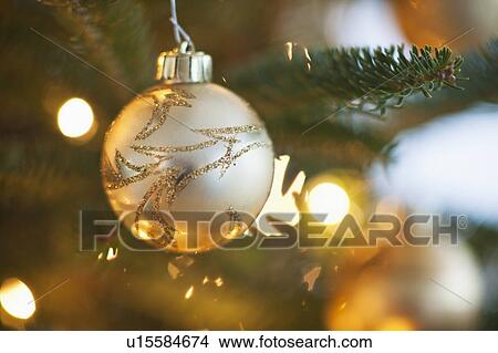Christmas decoration hanging on Christmas tree, studio shot View Large Photo Image Picture - Christmas decoration hanging on Christmas tree, studio shot. Fotosearch