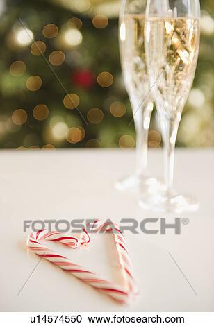 Christmas heart shaped candy canes near champagne View Large Photo Image Stock Image - Christmas heart shaped candy canes near champagne. Fotosearch