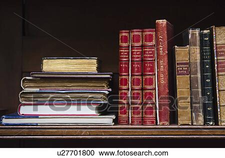Stock Image - Close up of antique books on shelf. Fotosearch