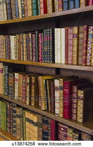 Close up of antique books on shelves View Large Photo Image Stock Photo - Close up of antique books on shelves. Fotosearch