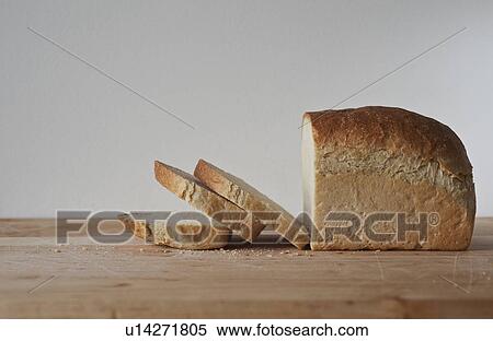 Close up of bread slices on cutting board View Large Photo Image Stock Photography - Close up of bread slices on cutting board. Fotosearch