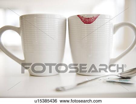 Close up of coffee mugs, one with red lipstick sign on edge View Large Photo Image Stock Photograph - Close up of coffee mugs, one with red lipstick sign on edge. Fotosearch
