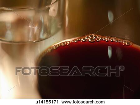 Stock Image - Close-up of glass with red wine. Fotosearch