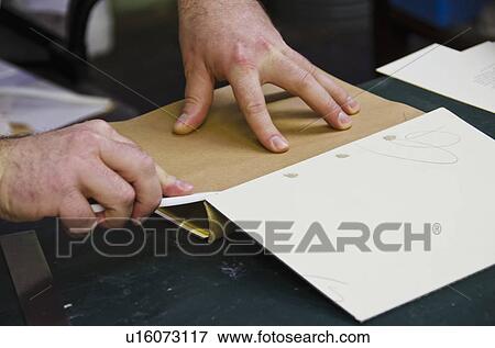 Stock Photo - Close up of hands of book binder. Fotosearch