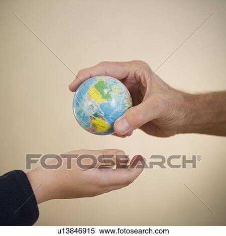 Close up of hands of grandfather and grandson (8-9) with small globe View Large Photo Image Stock Photography - Close up of hands of grandfather and grandson (8-9) with small globe. Fotosearch