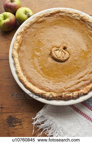 Close up of pumpkin pie and apples on table View Large Photo Image Stock Photography - Close up of pumpkin pie and apples on table. Fotosearch