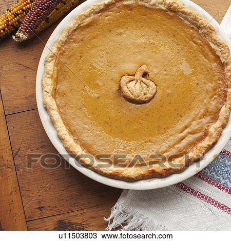 Stock Image - Close up of pumpkin pie on table. Fotosearch