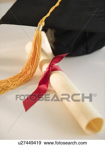Close up of rolled diploma and mortarboard View Large Photo Image Stock Photo - Close up of rolled diploma and mortarboard. Fotosearch