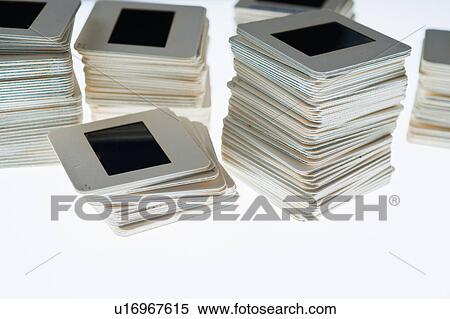 Stock Photography - Close up of slides in piles on light box. Fotosearch