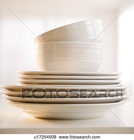 Stock Photo - Close up of stack of dinnerware. Fotosearch