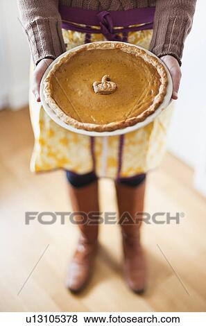 Close up of woman holding pumpkin pie View Large Photo Image Stock Photo - Close up of woman holding pumpkin pie. Fotosearch
