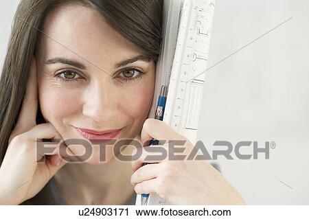 Close-up of woman holding ruler and pencil View Large Photo Image Stock Image - Close-up of woman holding ruler and pencil. Fotosearch