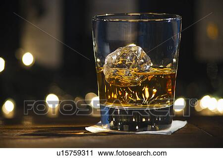 Stock Image - Close-up view of bourbon on bar counter. Fotosearch