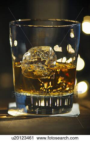 Stock Image - Close-up view of bourbon on bar counter. Fotosearch