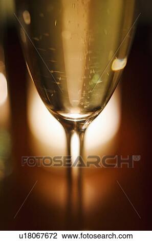 Close-up view of champagne glass View Large Photo Image Stock Image - Close-up view of champagne glass. Fotosearch
