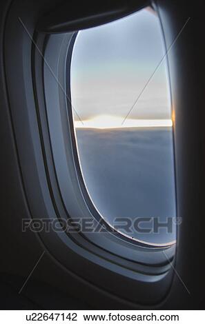 Clouds seen through airplane window View Large Photo Image Stock Image - Clouds seen through airplane window. Fotosearch