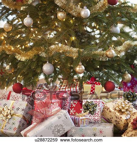Stock Photo - Colorful gifts under christmas tree. Fotosearch