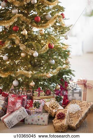 Stock Photography - Colorful gifts under christmas tree. Fotosearch