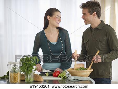 Couple cooking in kitchen View Large Photo Image Stock Image - Couple cooking in kitchen. Fotosearch
