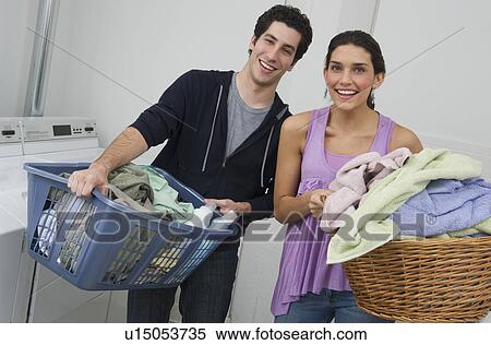 Couple doing laundry View Large Photo Image Stock Photography - Couple doing laundry. Fotosearch
