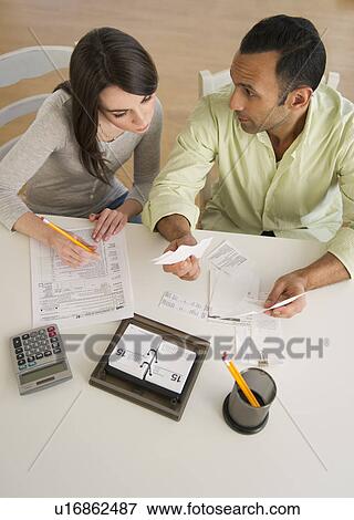 Couple doing taxes View Large Photo Image Stock Photo - Couple doing taxes. Fotosearch