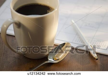 Cup of coffee beside calendar View Large Photo Image Stock Image - Cup of coffee beside calendar. Fotosearch