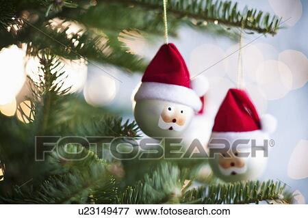 Stock Photo - Father Christmas baubles on tree. Fotosearch