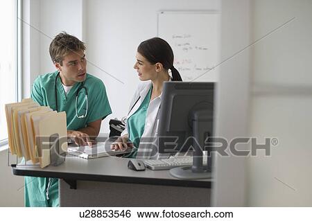 Female doctor and surgeon working in office View Large Photo Image Stock Photograph - Female doctor and surgeon working in office. Fotosearch