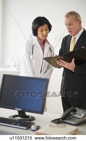 Stock Photography - Female doctor s with hospital executive. Fotosearch