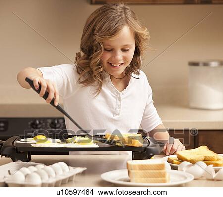 Girl (10-11) preparing breakfast in kitchen View Large Photo Image Picture - Girl (10-11) preparing breakfast in kitchen. Fotosearch