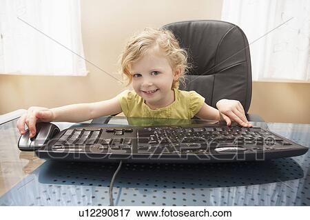 Stock Photo - Girl (2-3) playing on computer. Fotosearch