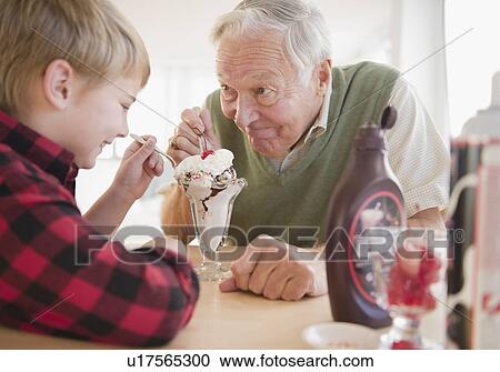 Grandfather and grandson (8-9) eating ice cream View Large Photo Image Stock Image - Grandfather and grandson (8-9) eating ice cream. Fotosearch
