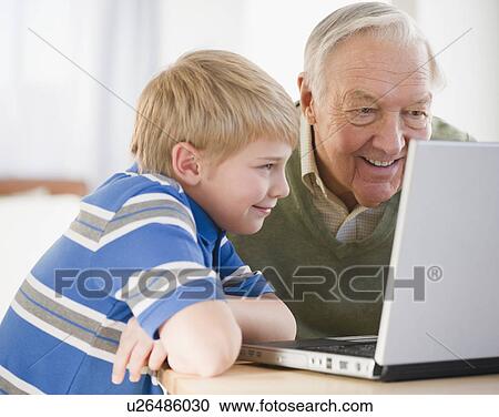 Grandfather and grandson (8-9) using laptop View Large Photo Image Stock Image - Grandfather and grandson (8-9) using laptop. Fotosearch
