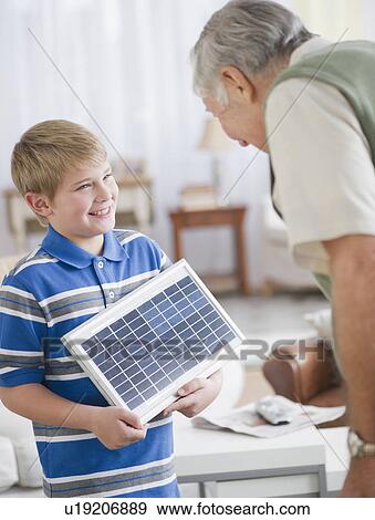 Grandson (8-9) showing solar panel to Grandfather View Large Photo Image Stock Photo - Grandson (8-9) showing solar panel to Grandfather. Fotosearch