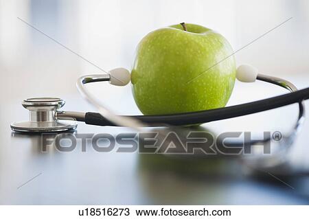 Stock Image - Green apple with stethoscope. Fotosearch