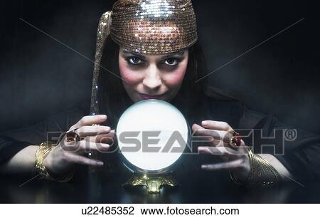 Stock Image - Gypsy woman with crystal ball. Fotosearch