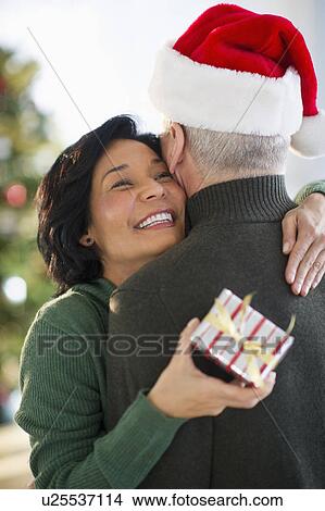 Picture - Happy mature couple on christmas time. Fotosearch