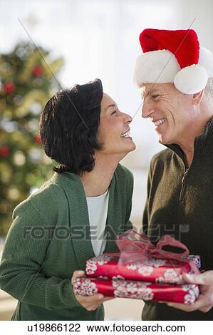 Happy mature couple on christmas time View Large Photo Image Stock Image - Happy mature couple on christmas time. Fotosearch