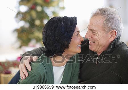 Stock Photo - Happy mature couple on christmas time. Fotosearch