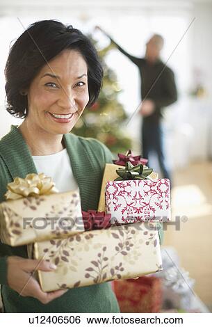 Stock Photograph - Happy mature couple on christmas time. Fotosearch