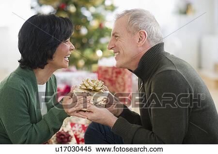 Stock Photography - Happy mature couple on christmas time. Fotosearch